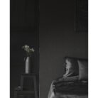 White,Flowers,On,Stool,Next,To,Bed,With,Cushion,In