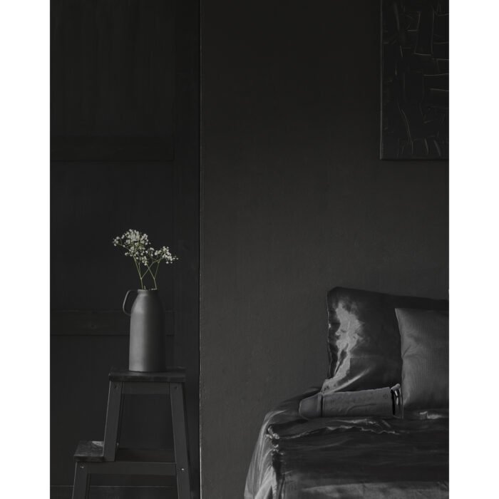 White,Flowers,On,Stool,Next,To,Bed,With,Cushion,In White,Flowers,On,Stool,Next,To,Bed,With,Cushion,In